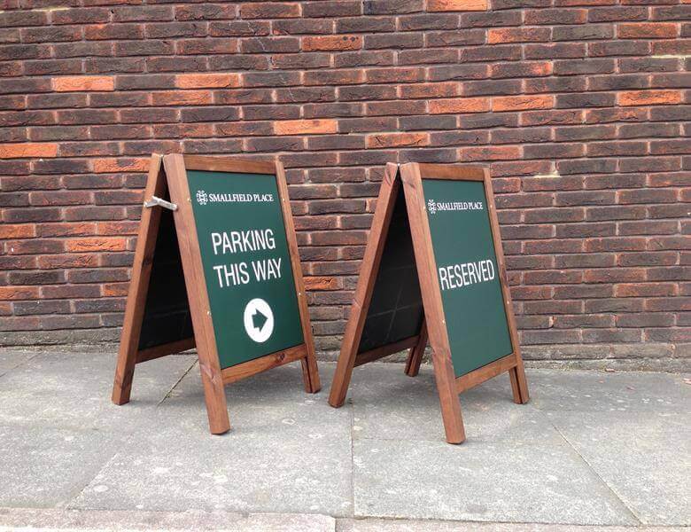 Parking this way sign